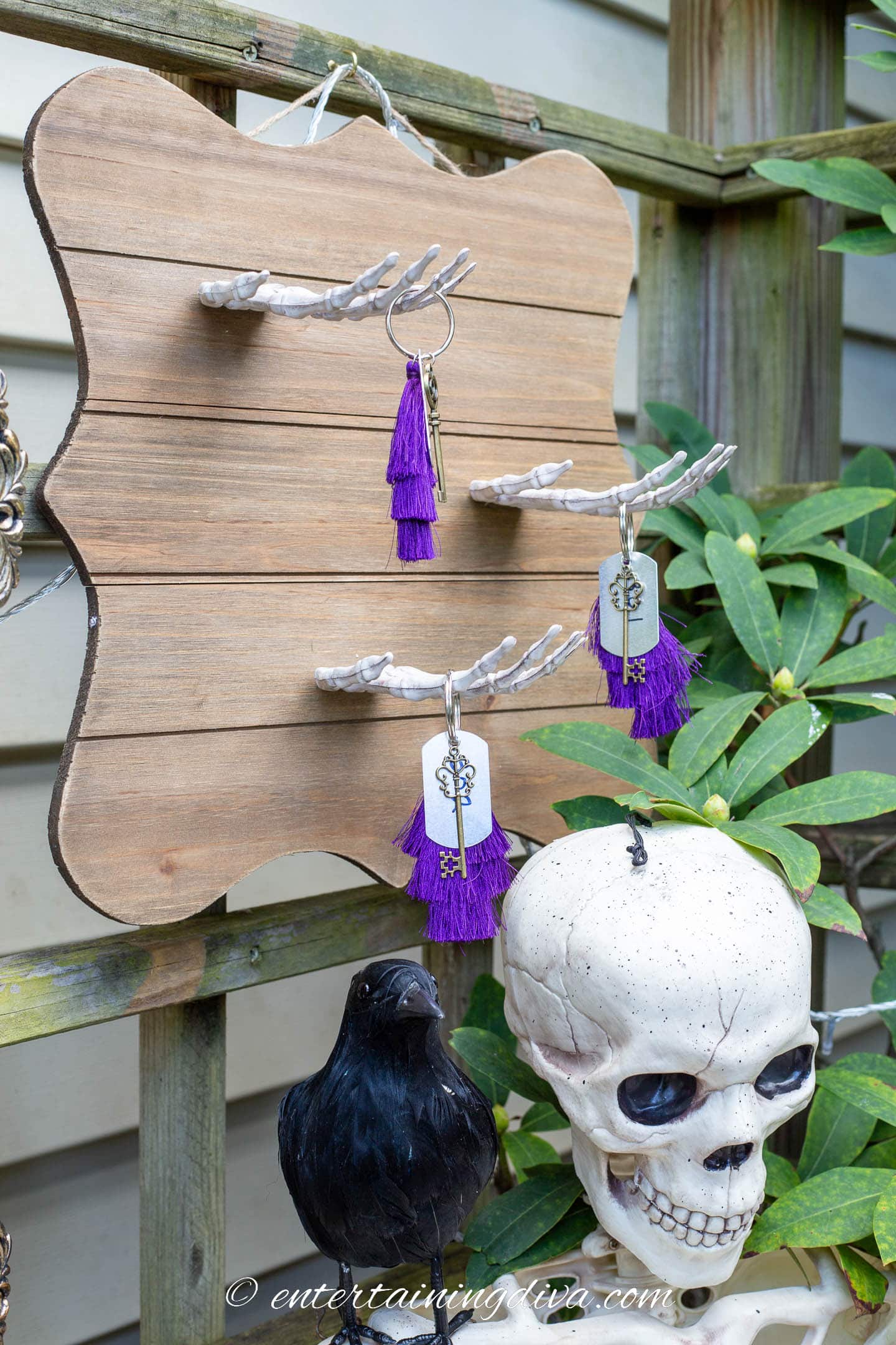 DIY skeleton hand Halloween wall decor with old fashioned keys hung from it