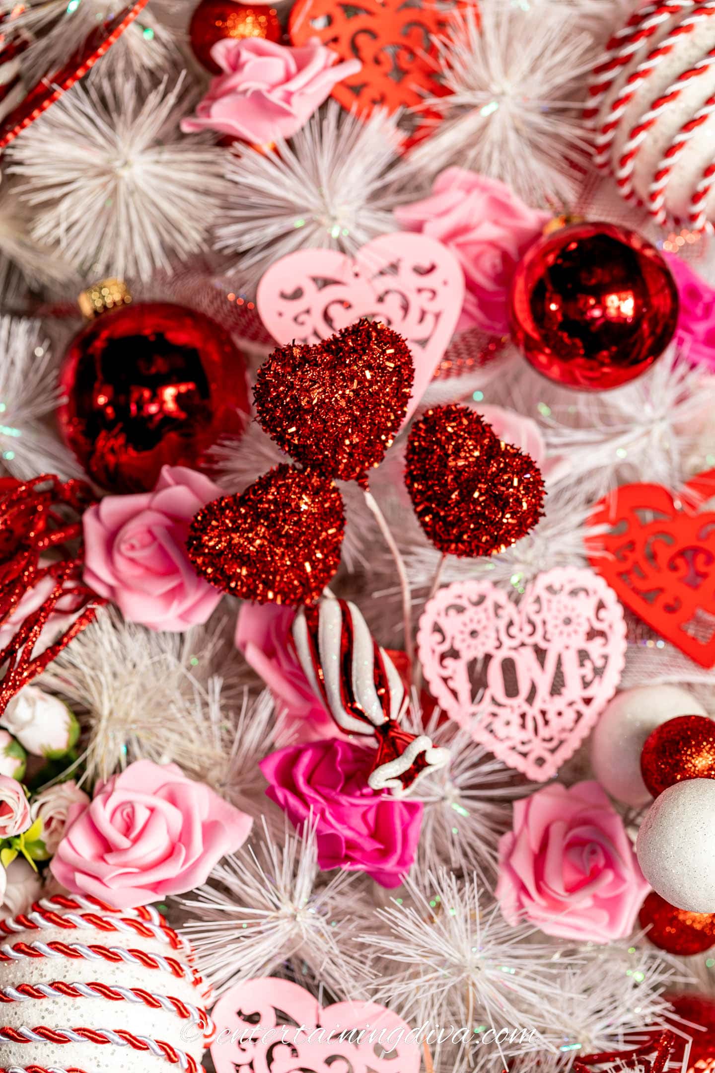 Red heart picks on a white Valentine tree with pink hearts and roses ornaments