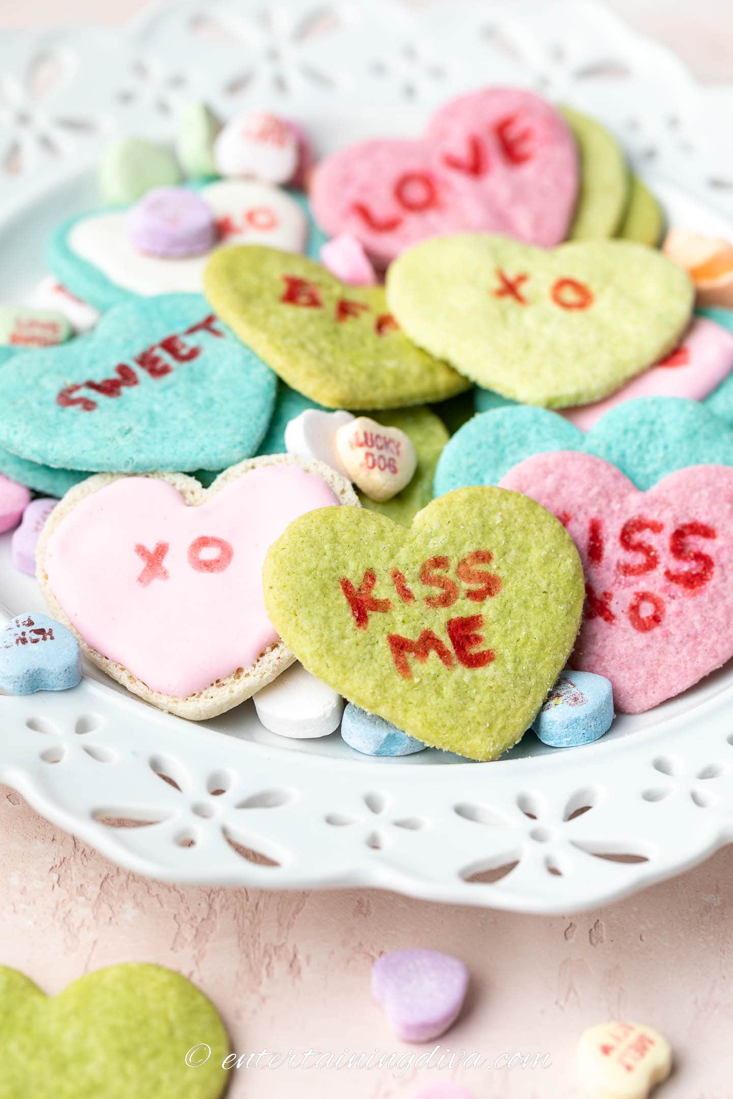 conversation heart cookies on a plate with conversation heart candies