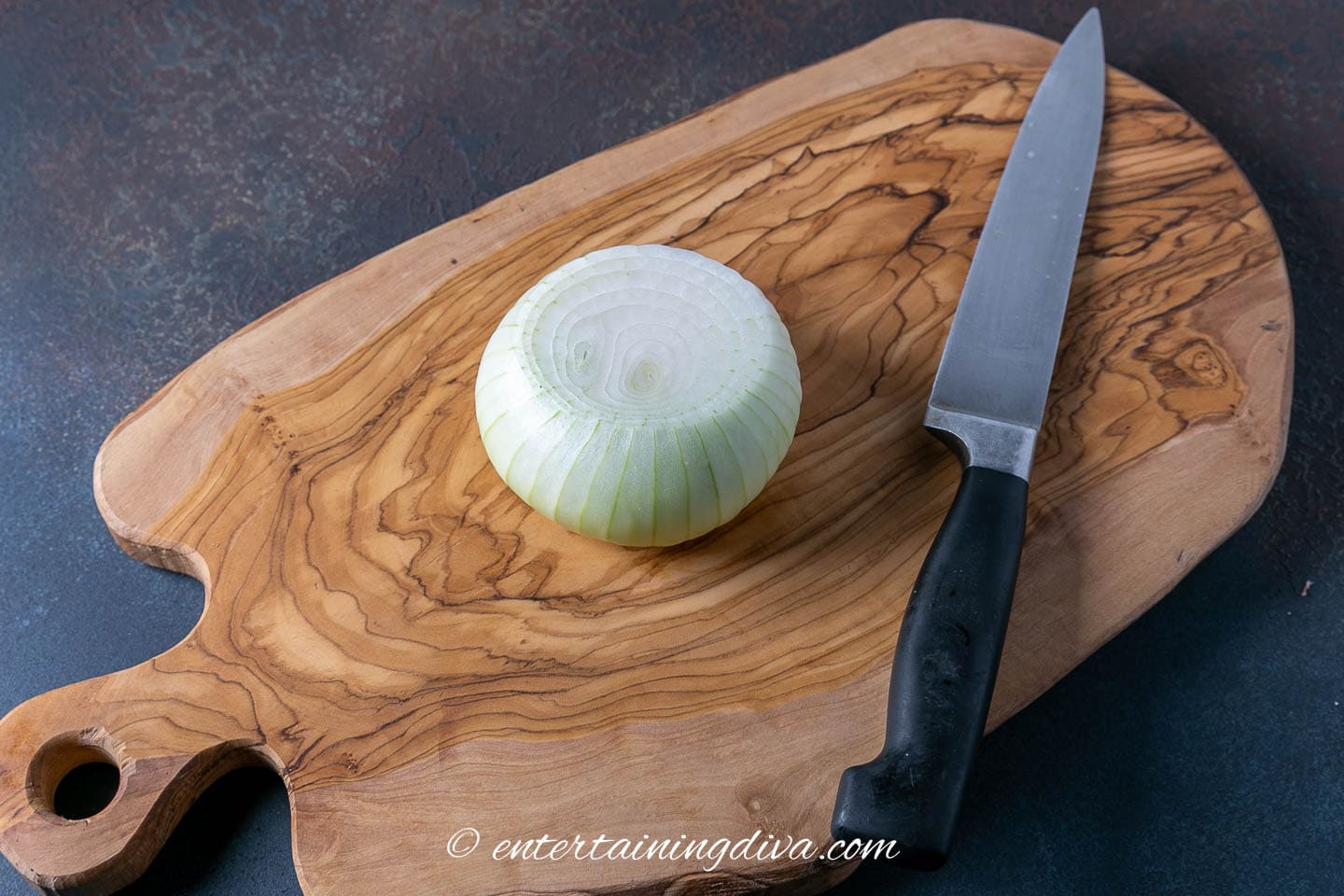 onion and a knife on a chopping board