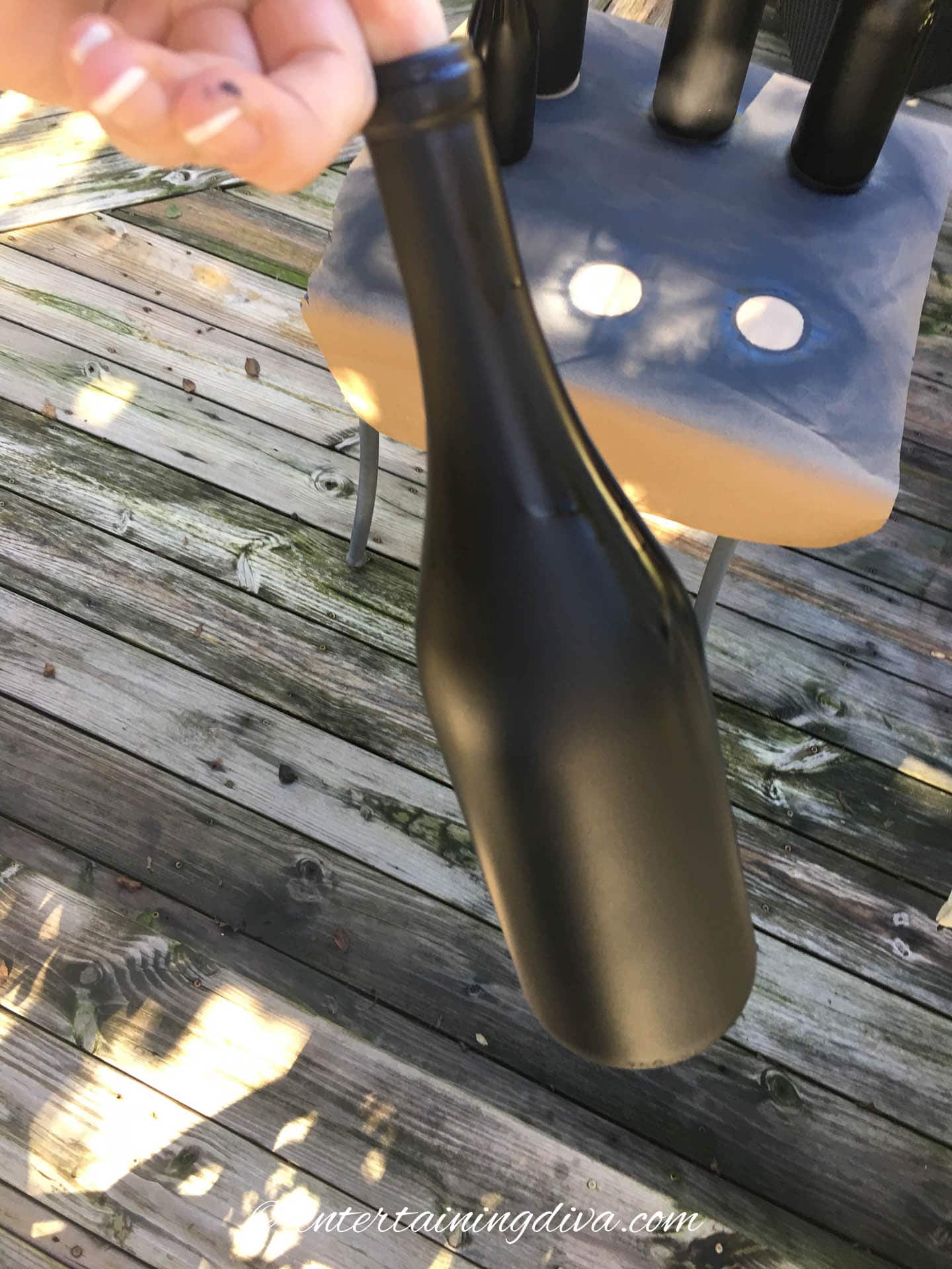 Wine bottle spray painted with flat black paint
