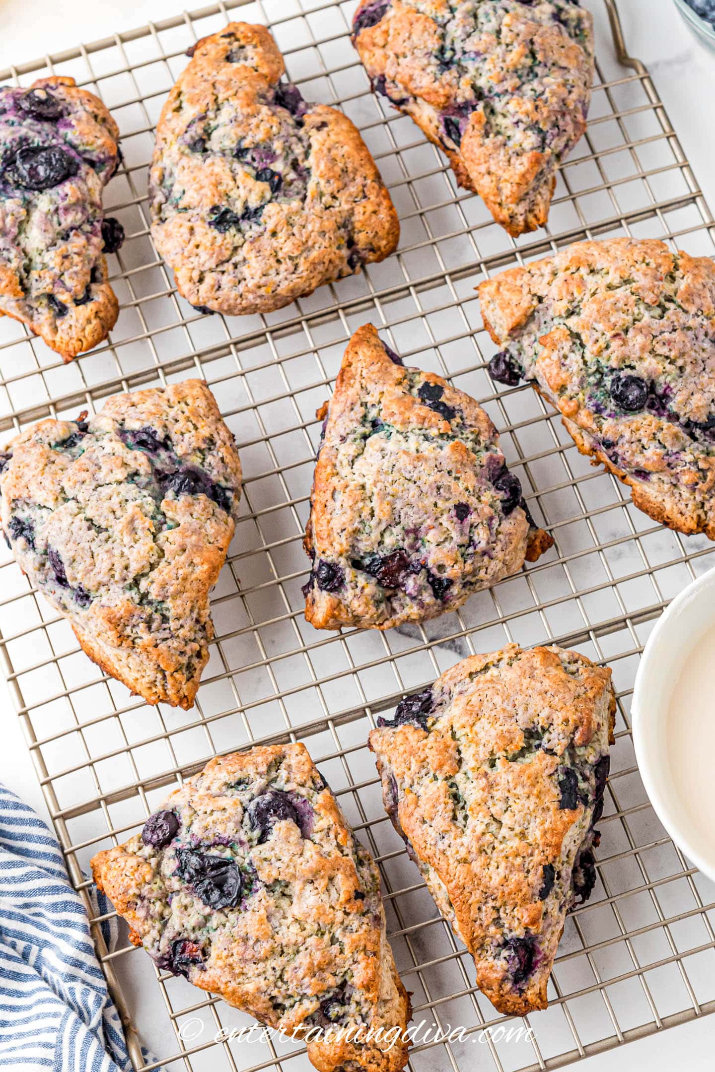 lemon blueberry scones on a wire cooling rack after baking
