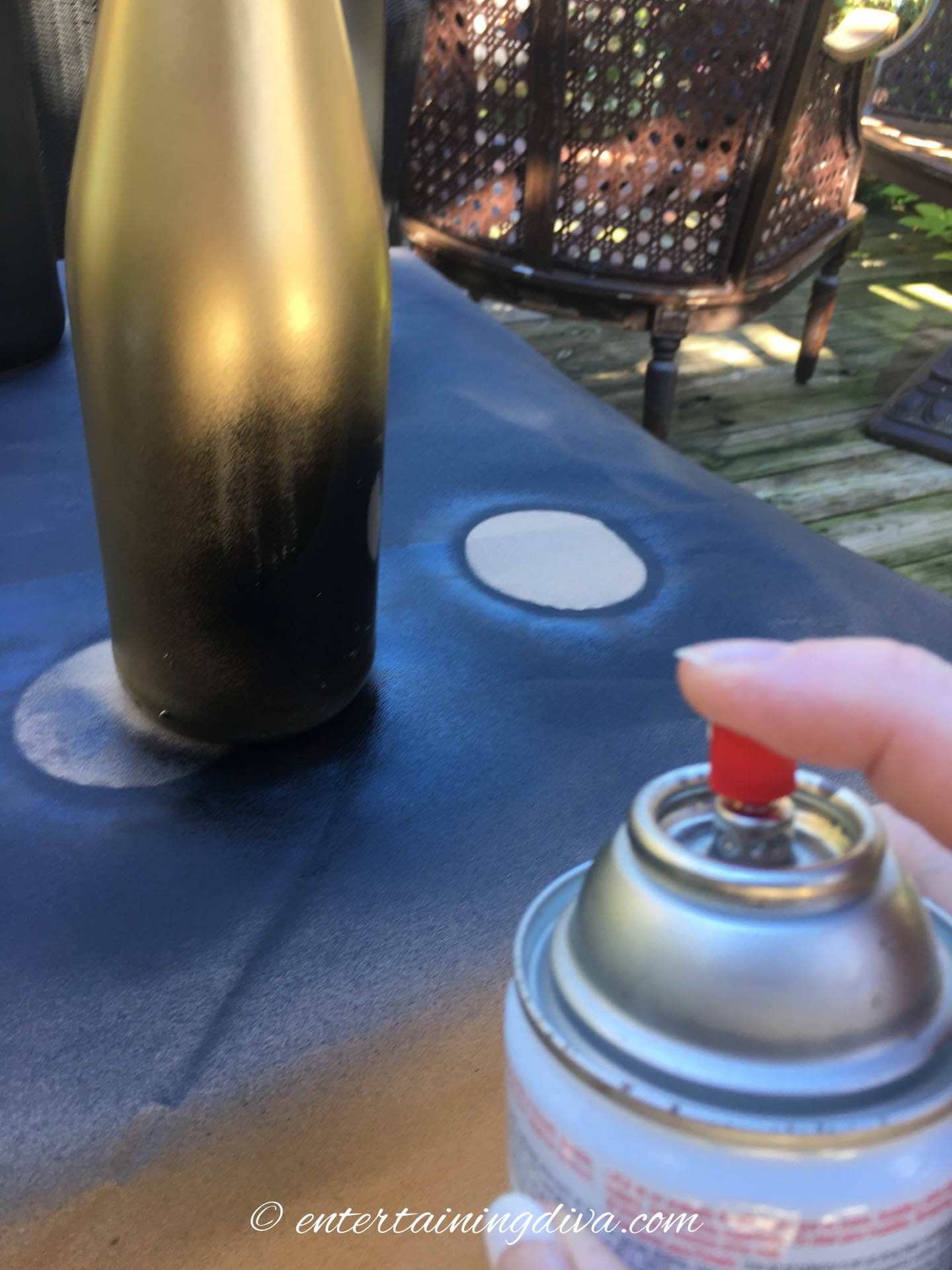 Spray painting the bottom of a gold wine bottle black