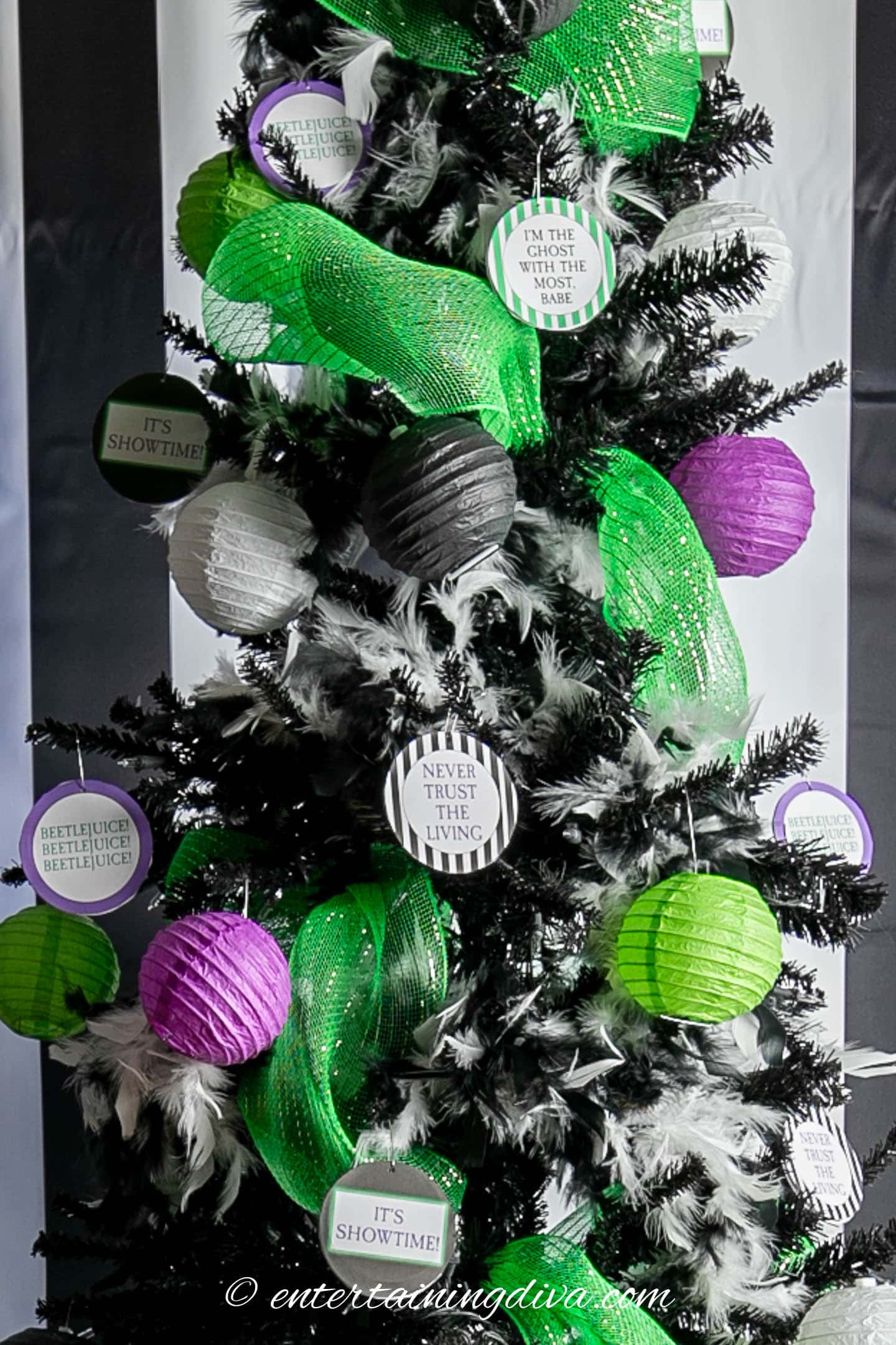 DIY Beetlejuice ornaments, hung on a black Halloween tree with other black, white, purple and green tree decorations