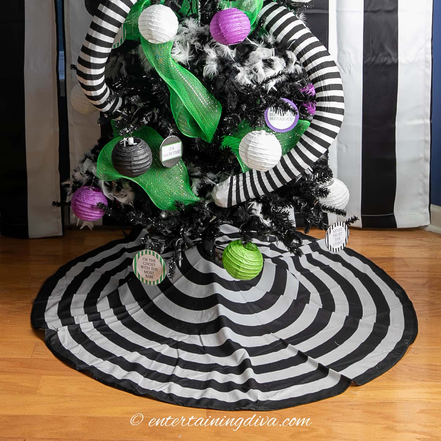 Black and white striped tree skirt at the bottom of a Beetlejuice Halloween tree