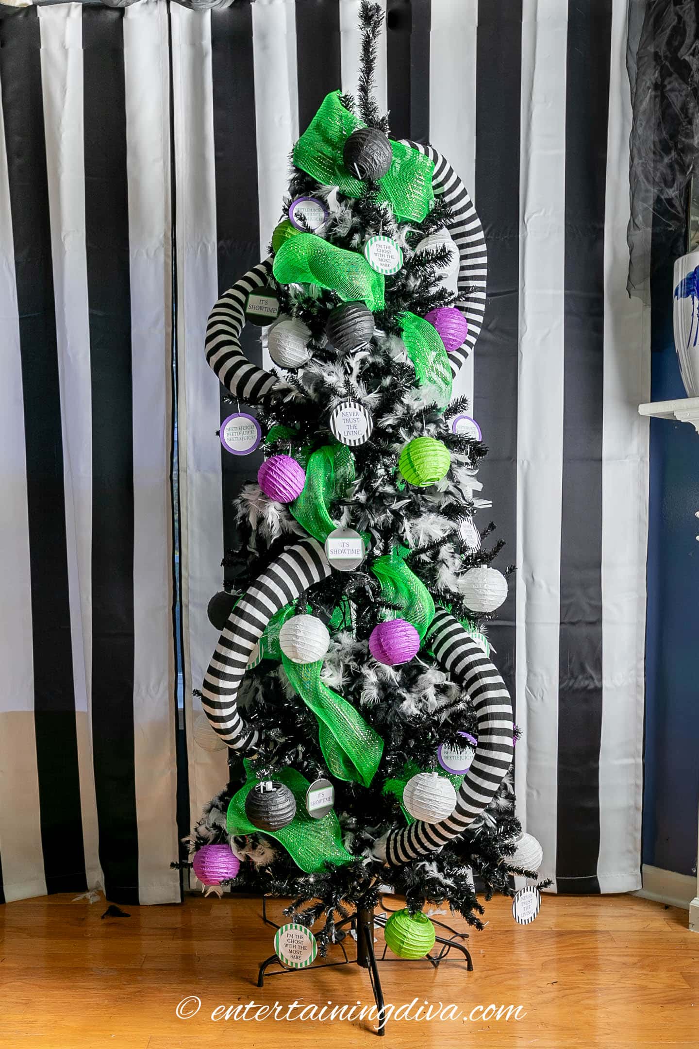 Black and white striped sandworms on a Beetlejuice Halloween tree with other black, white, purple and green decorations