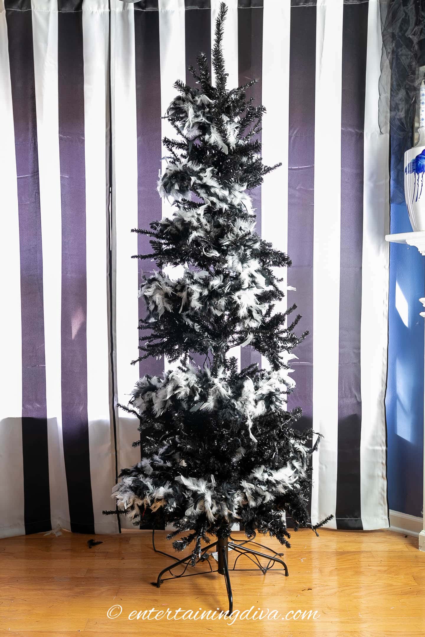 Black Halloween tree wrapped with white feather boas