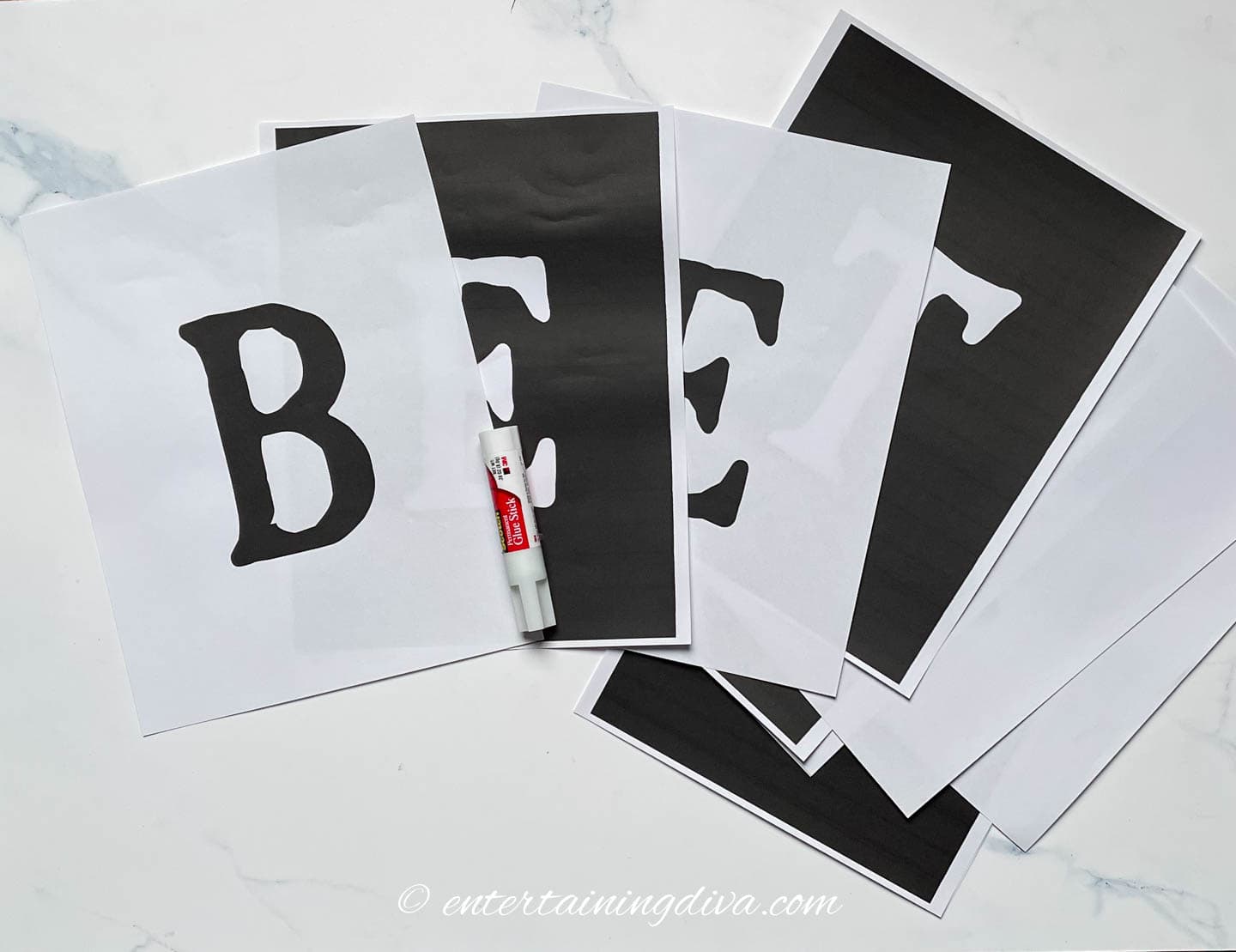 printed Beetlejuice banner letters and a glue gun