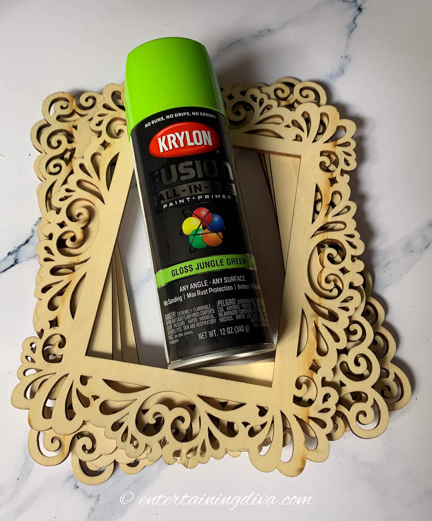 A can of lime green spray paint on top of unpainted wood frames