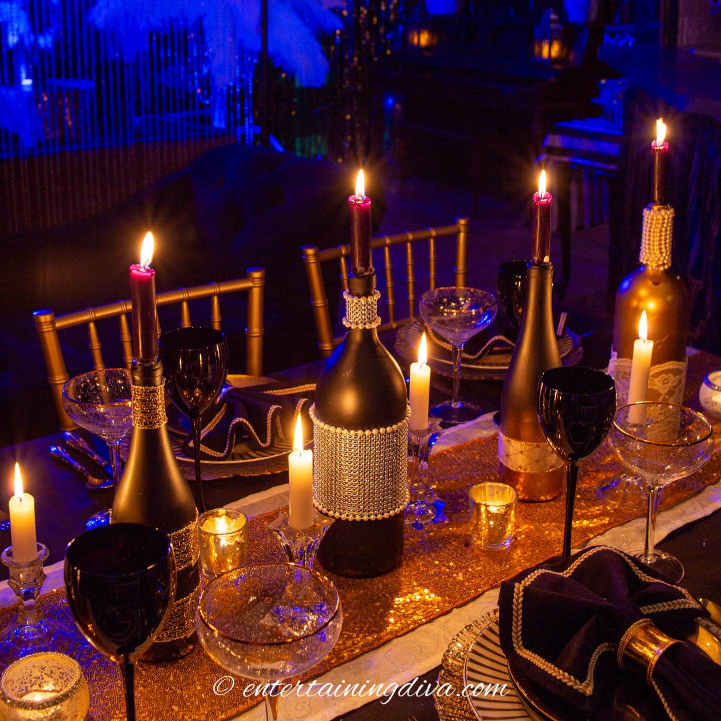 4 DIY wine bottle candleholders on a Gatsby party dinner table