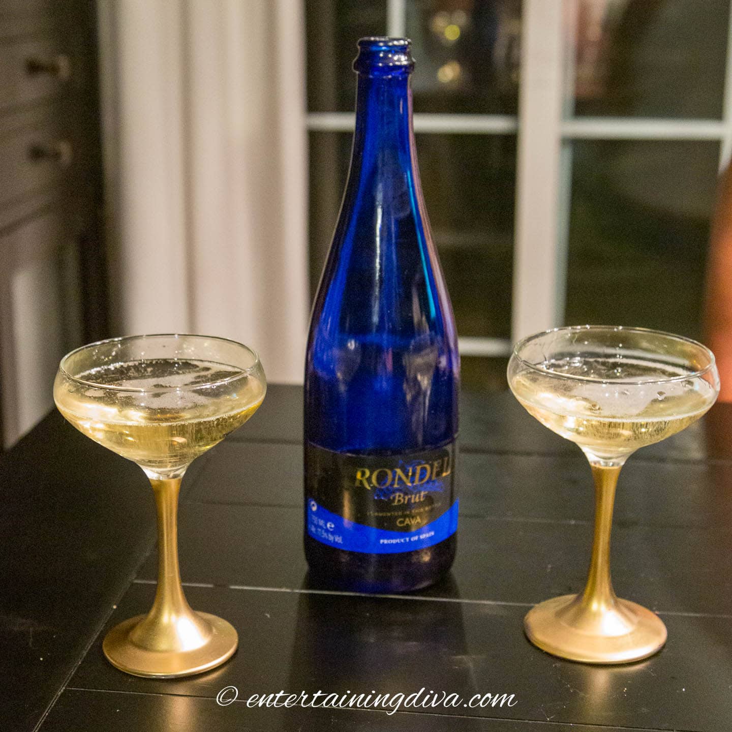 Two coupe glasses with stems painted gold