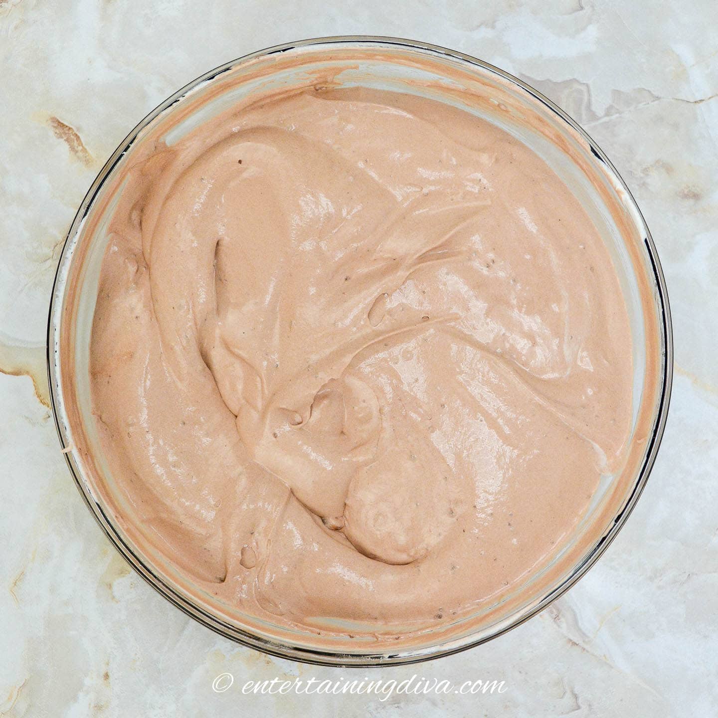 Chocolate pudding mixed with Cool Whip in a bowl