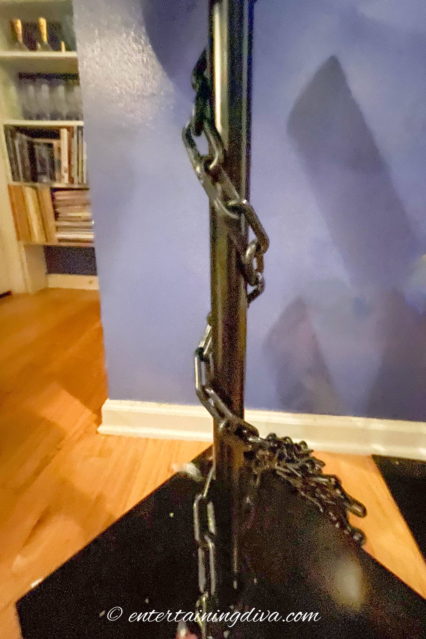 Chain wrapped around the bottom of a backdrop stand pole