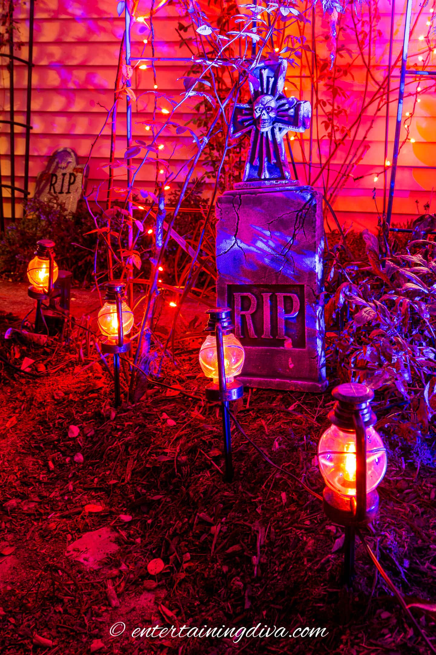 Purple and orange Halloween outdoor lighting with Halloween tombstone and path lighting