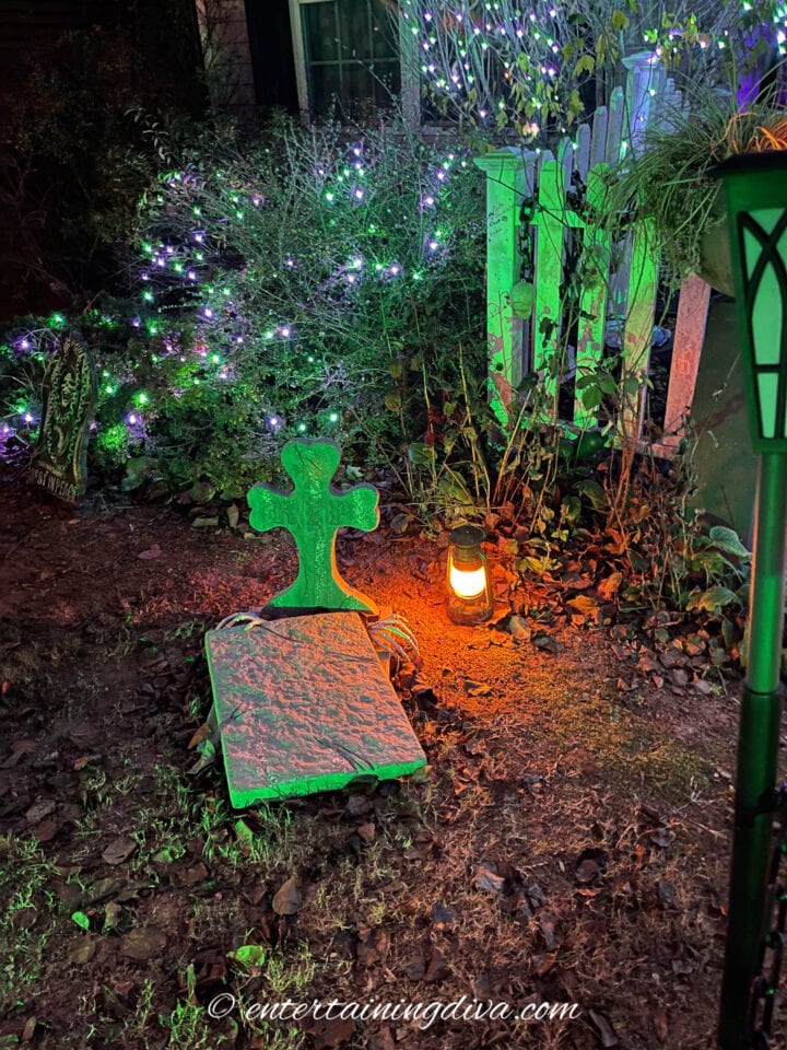 Halloween tombstone lit with a green flood light