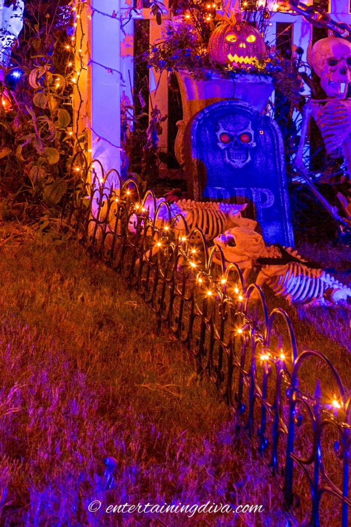 A house is decorated with outdoor lighting for Halloween.