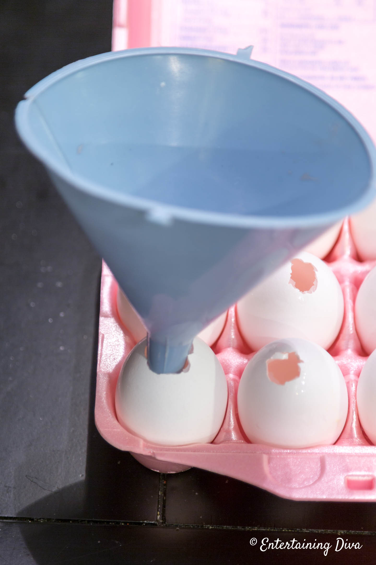 A funnel in a hole in an egg shell