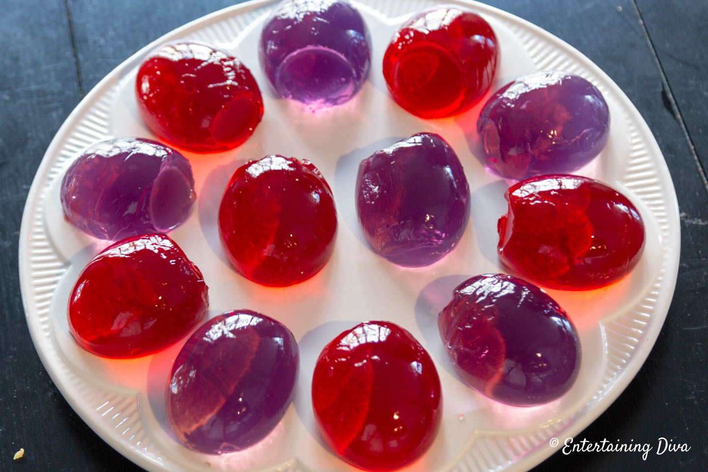 Red and purple Jello Easter eggs on a deviled egg plate