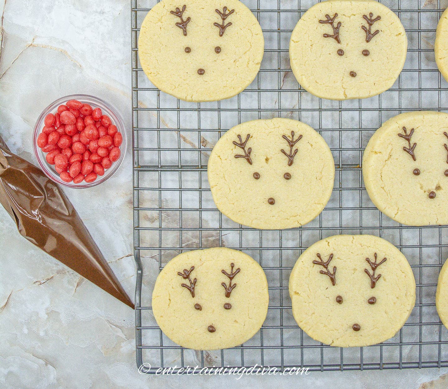 Reindeer cookies with antlers and eyes piped on in chocolate