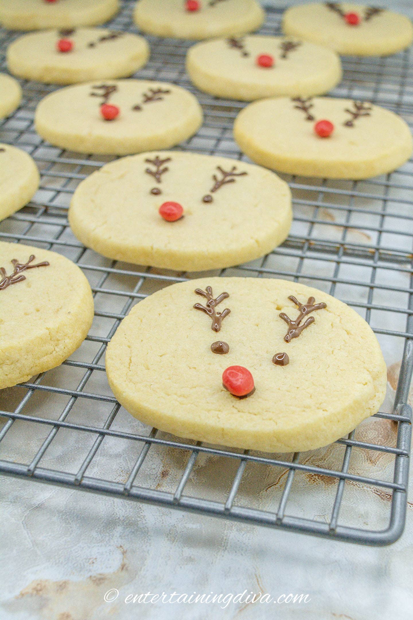 Reindeer sugar cookies on a cooling rack.