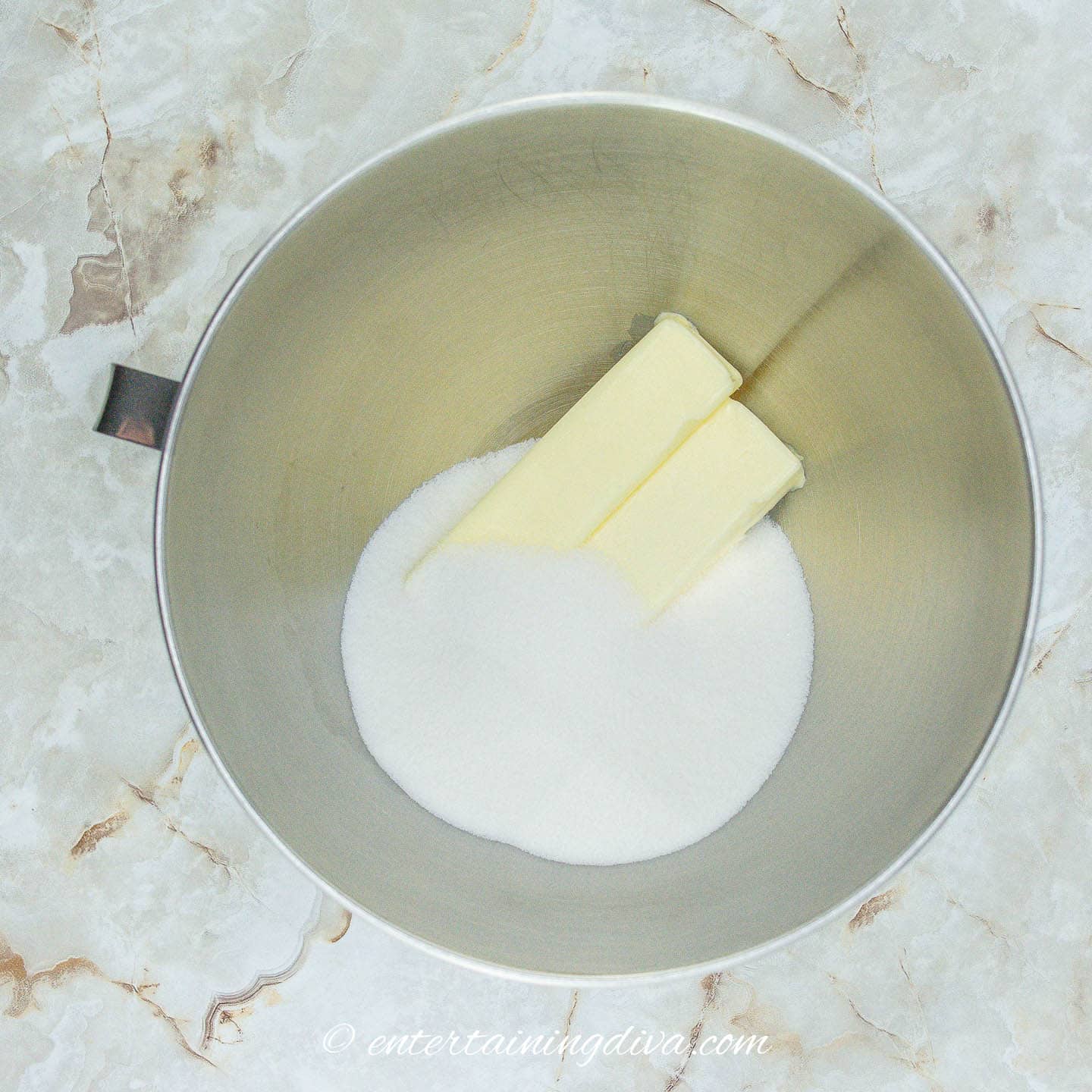 Butter and sugar in a metal bowl