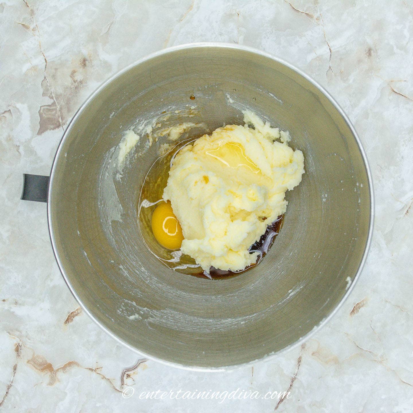 Creamed butter and sugar with egg and vanilla in a bowl
