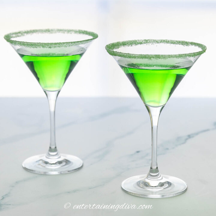 sour apple martini in martini glasses rimmed with green sugar