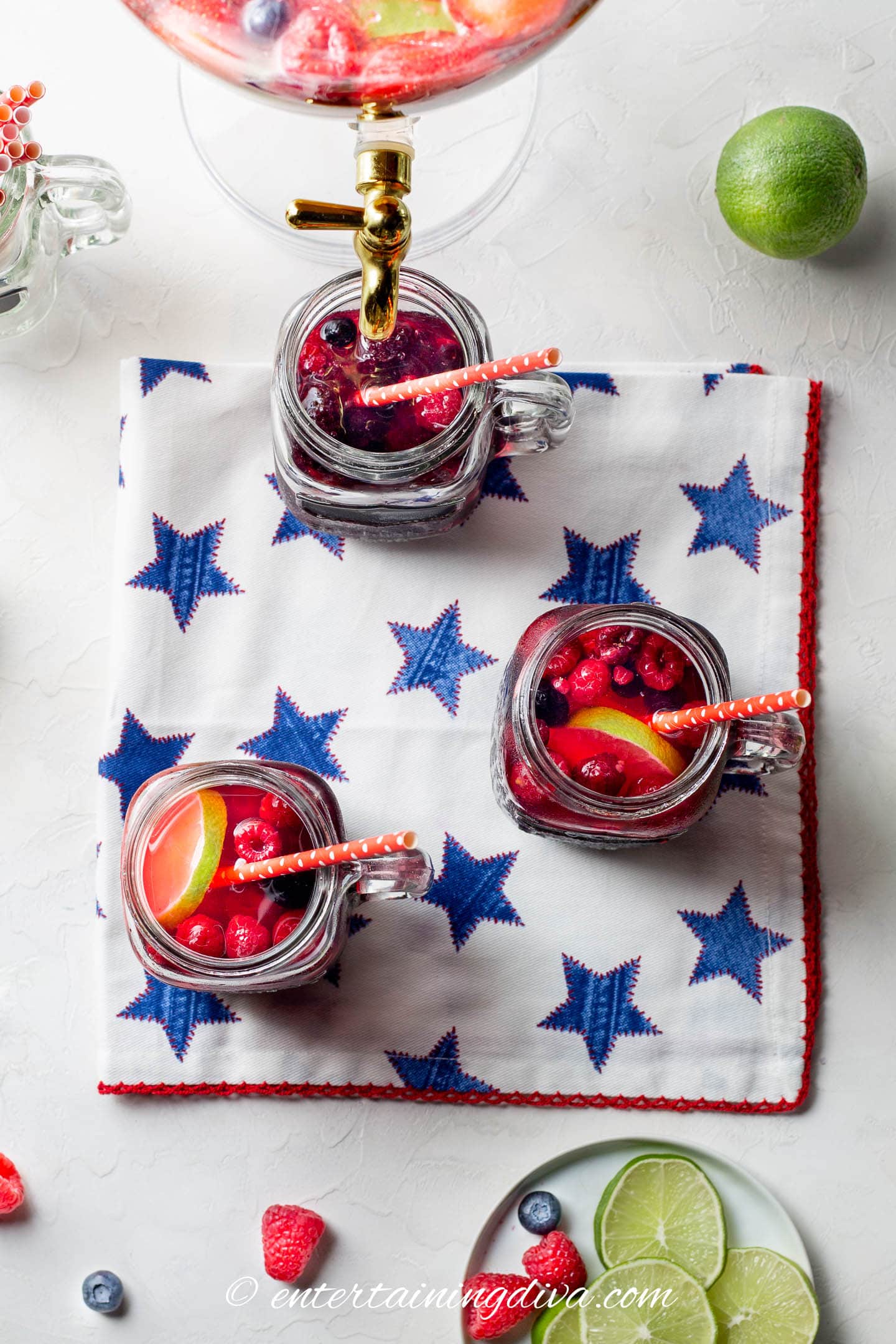 overhead picture of strawberry, raspberry and lime sangria in mason jar glasses