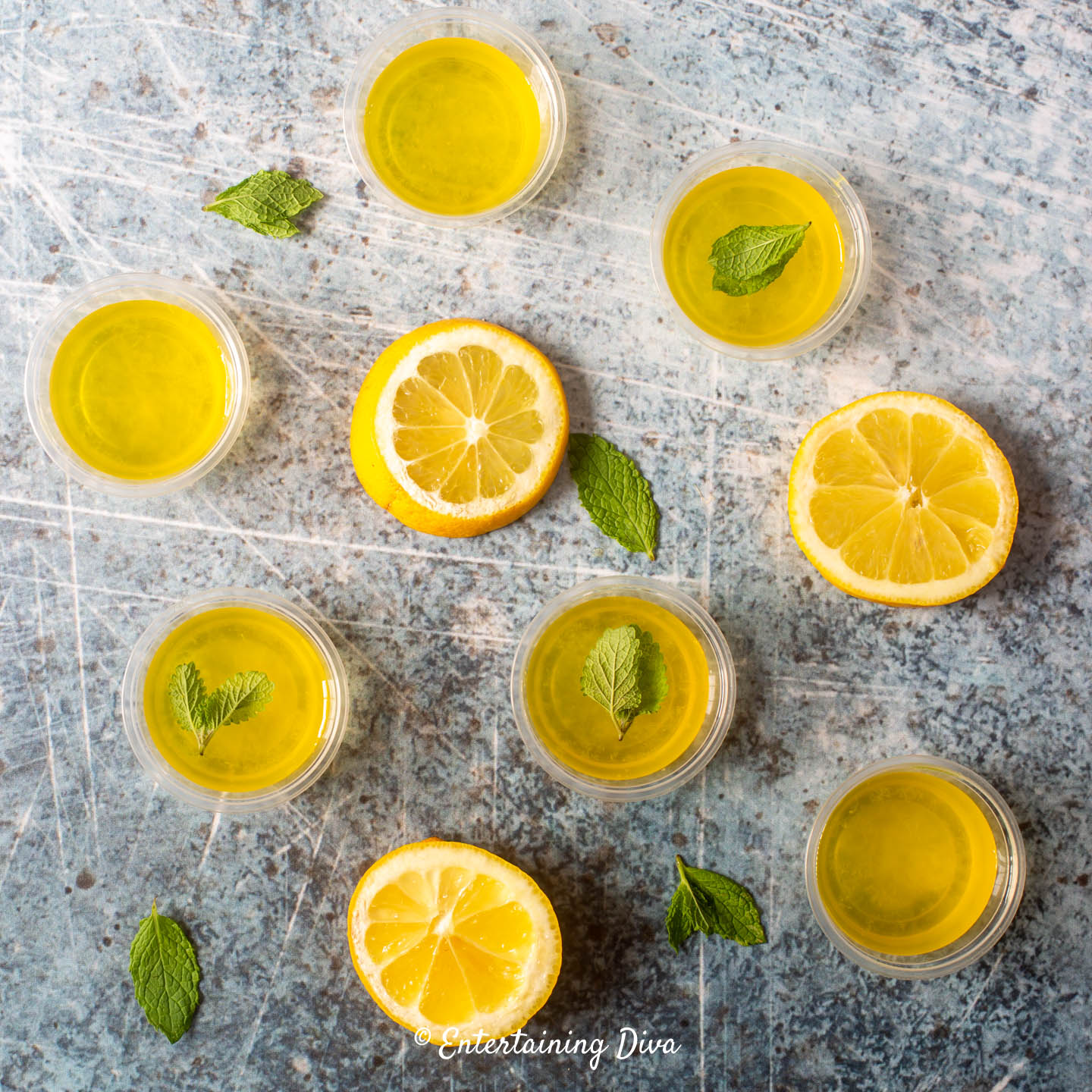 Lemon drop jello shots with slices of lemon and mint leaves Lemon drop jello shots with slices of lemon and mint leaves