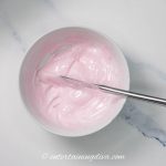 light pink royal icing in a bowl