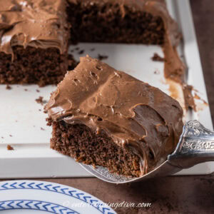 a close up of a piece of chocolate and coke soda cake with chocolate frosting