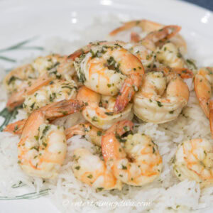 Thai red curry shrimp on a plate with rice