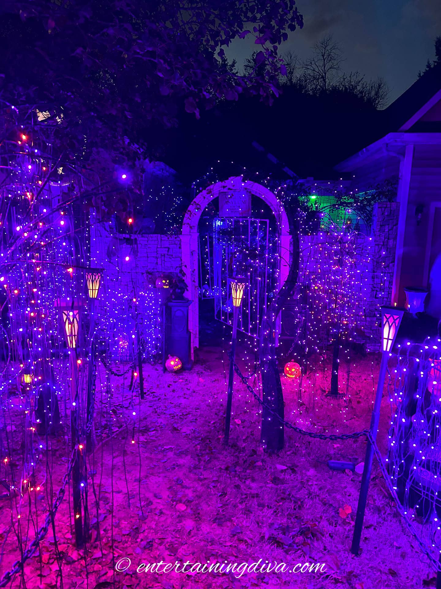 The front yard outdoor Halloween walkway with chain fence and solar lanterns