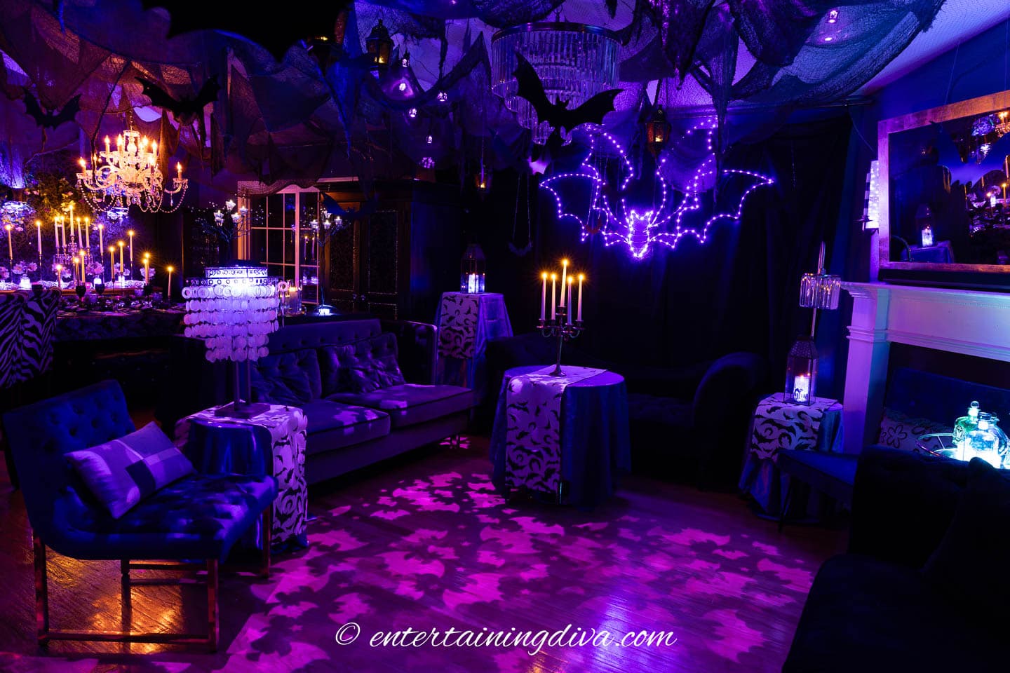 a living room decorated with bats and candles for batman Halloween party