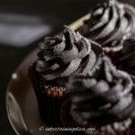close up of black chocolate buttercream frosting on cupcakes