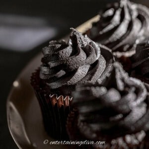 close up of black chocolate buttercream frosting on cupcakes