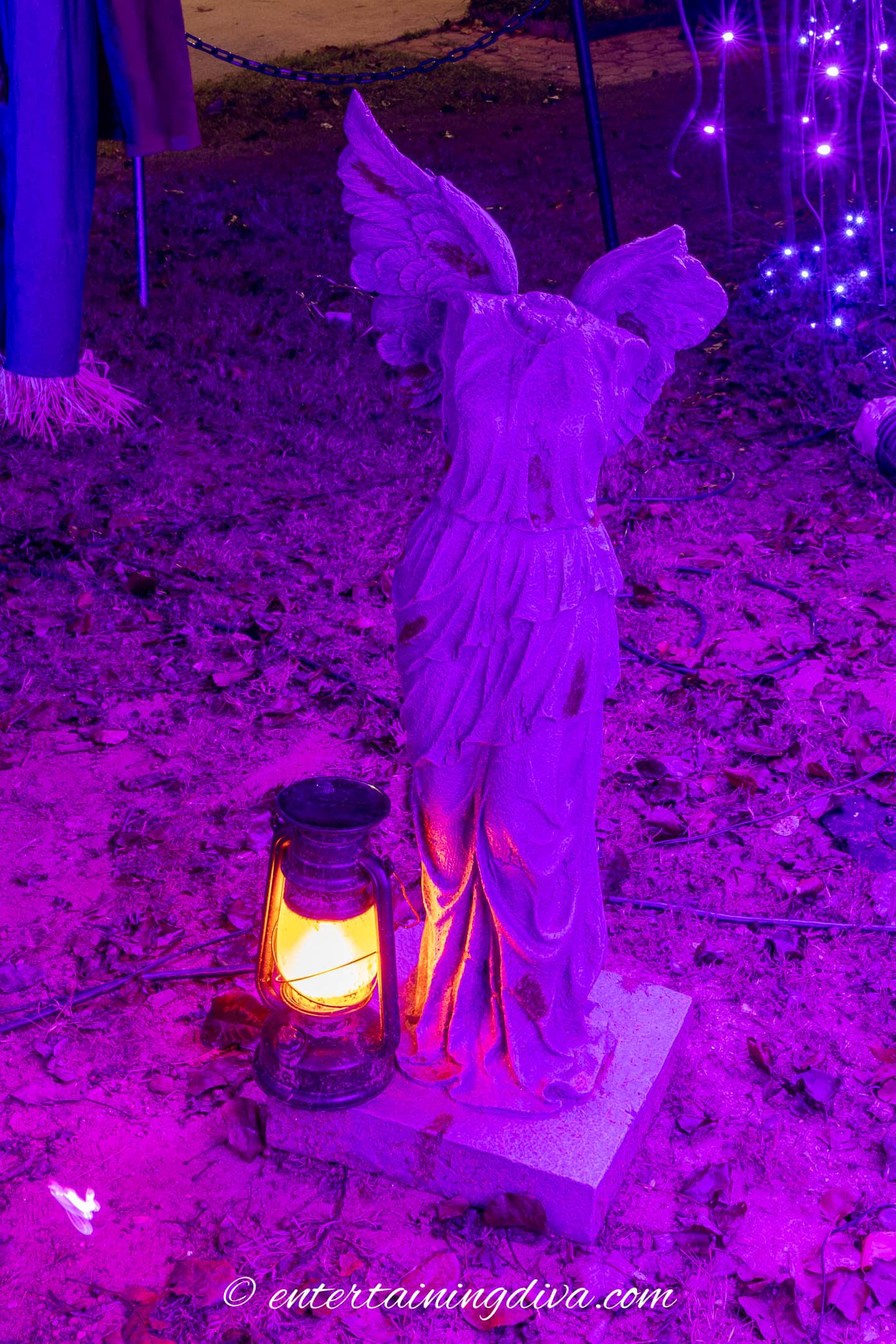 A solar lantern beside a headless angel statue