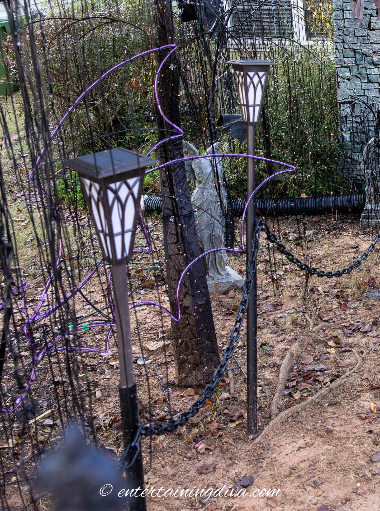 A Halloween fence made from PVC pipe and plastic chain
