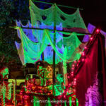 The sails of the DIY pirate ship lit up with blue and green flood lights