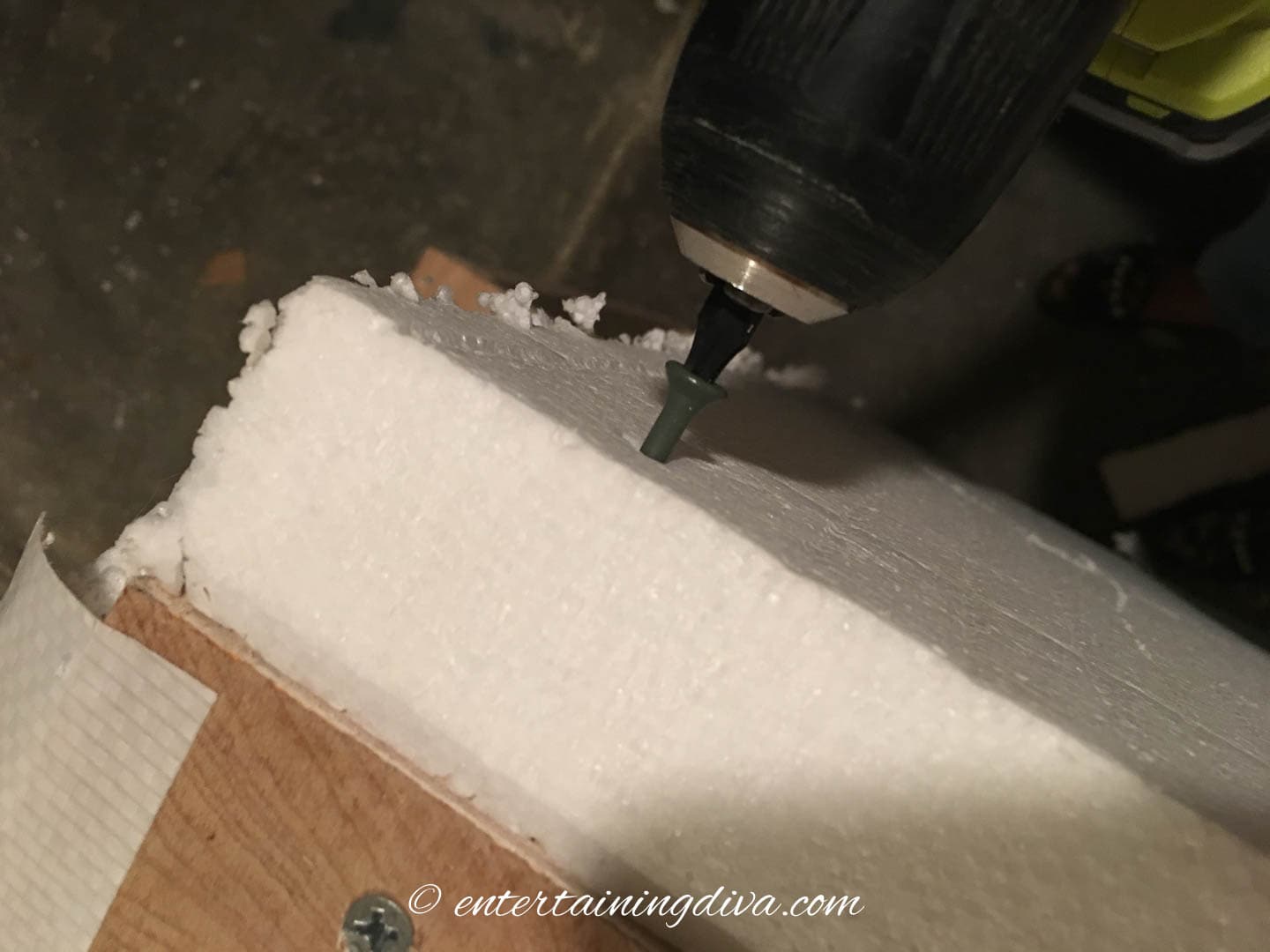 Styrofoam being screwed onto the frame of the pirate ship