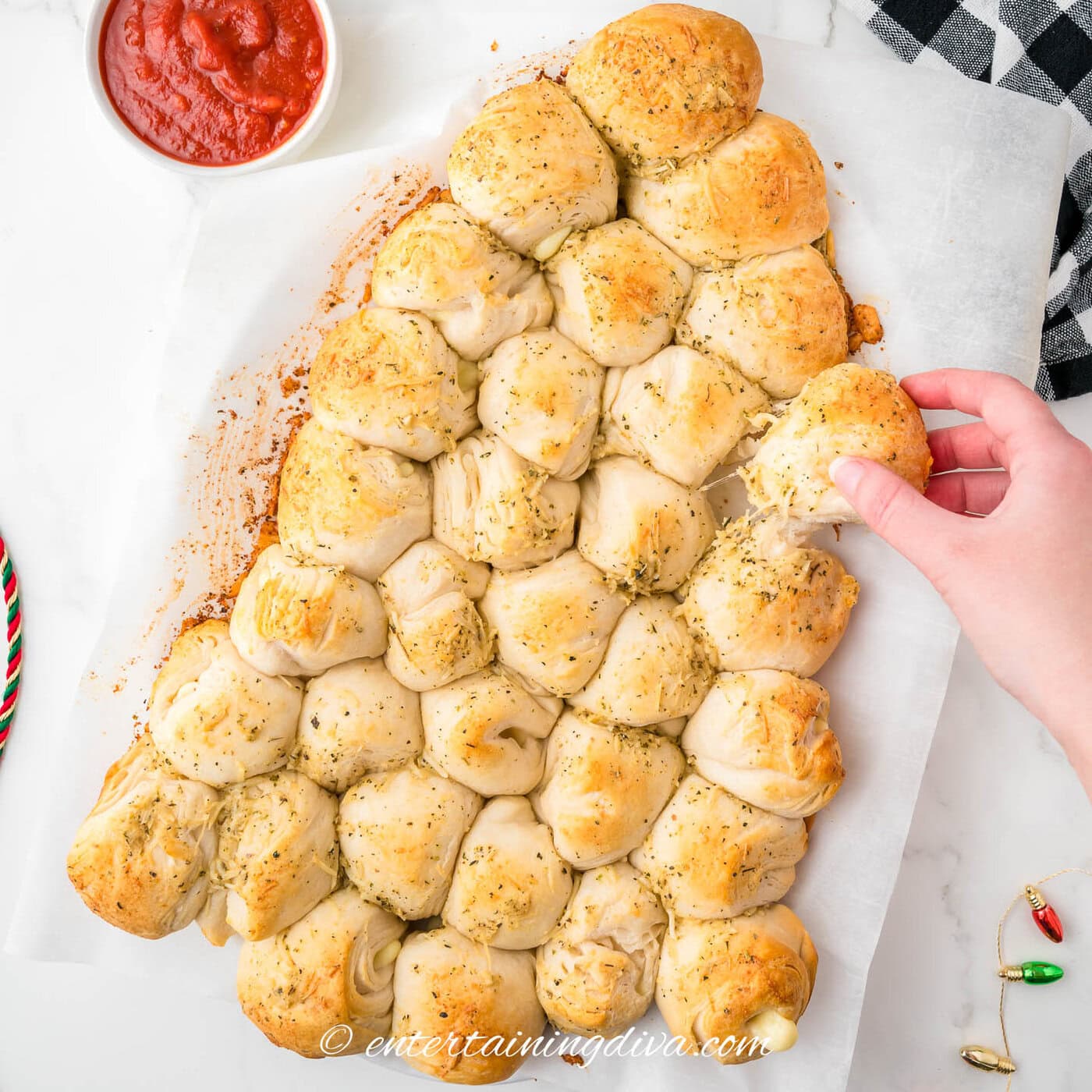 Christmas tree pull apart bread with a roll being pulled out