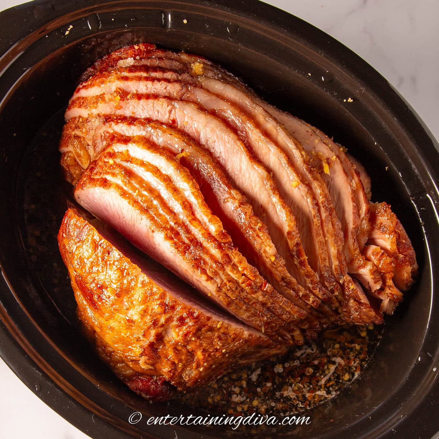 close up of a spiral ham in a slow cooker after cooking