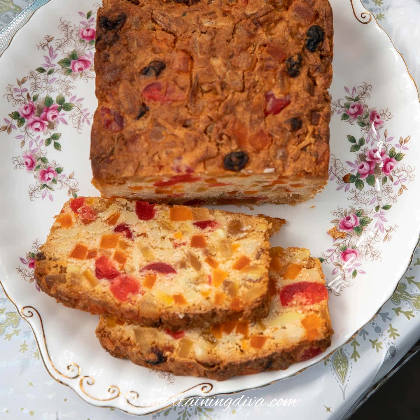 Two slices of Christmas fruit cake on a plate