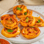 close up of pepperoni pinwheels on a plate