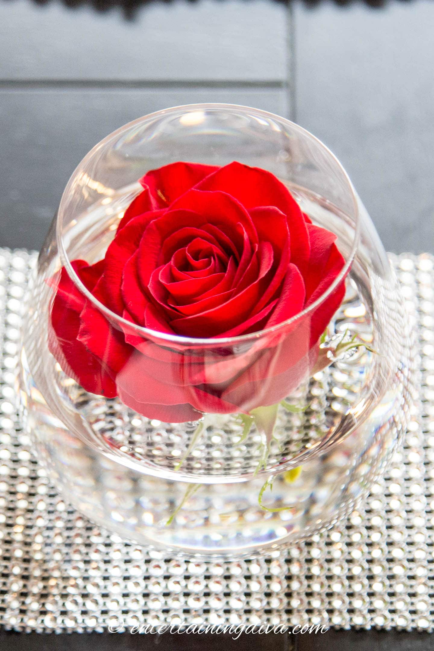 A red rose in a stemless wine glass
