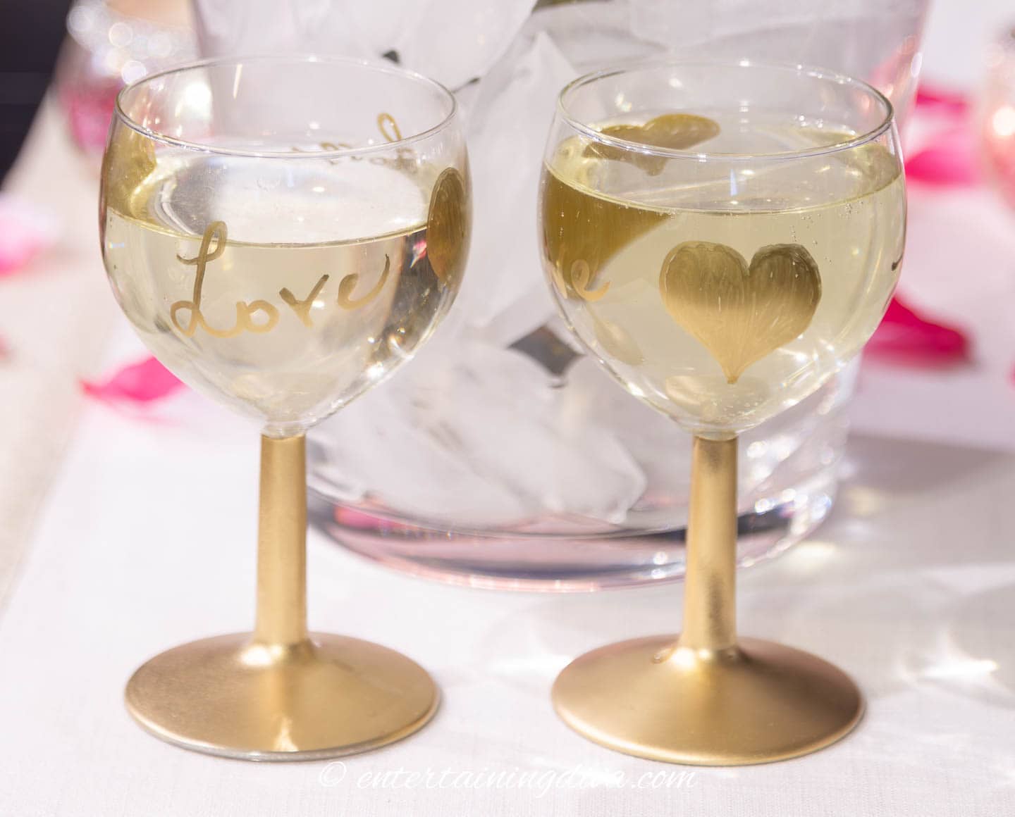 2 Valentine's Day wine glasses with champagne in them