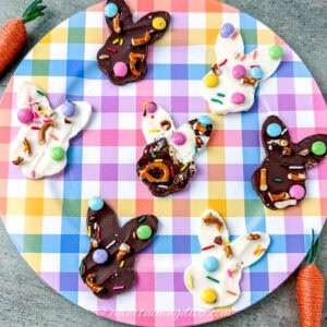 Bunny-shaped white and milk chocolate Easter bark on a colorful plate