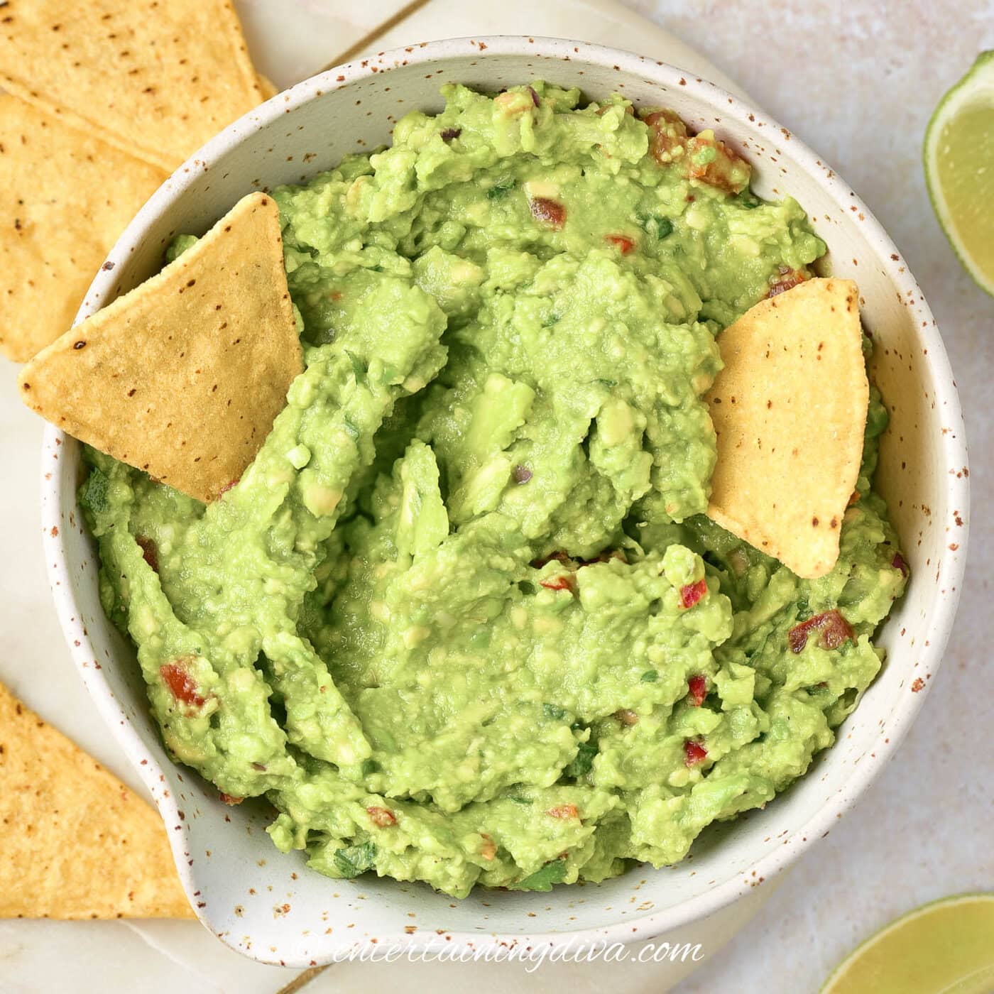 overhead shot of guacamole in a bowl with tortilla chips