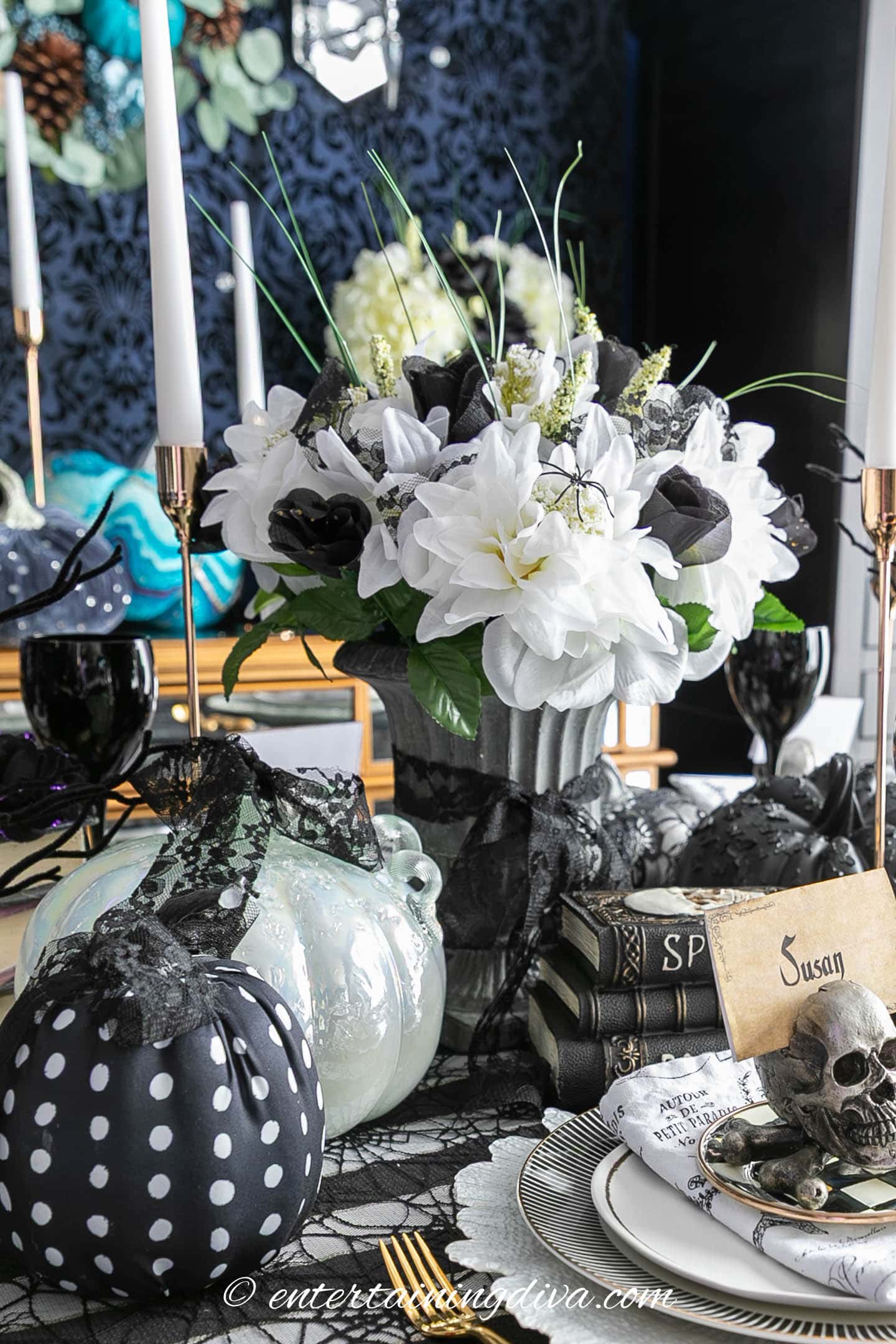 black and white faux flowers in a cement planter vase