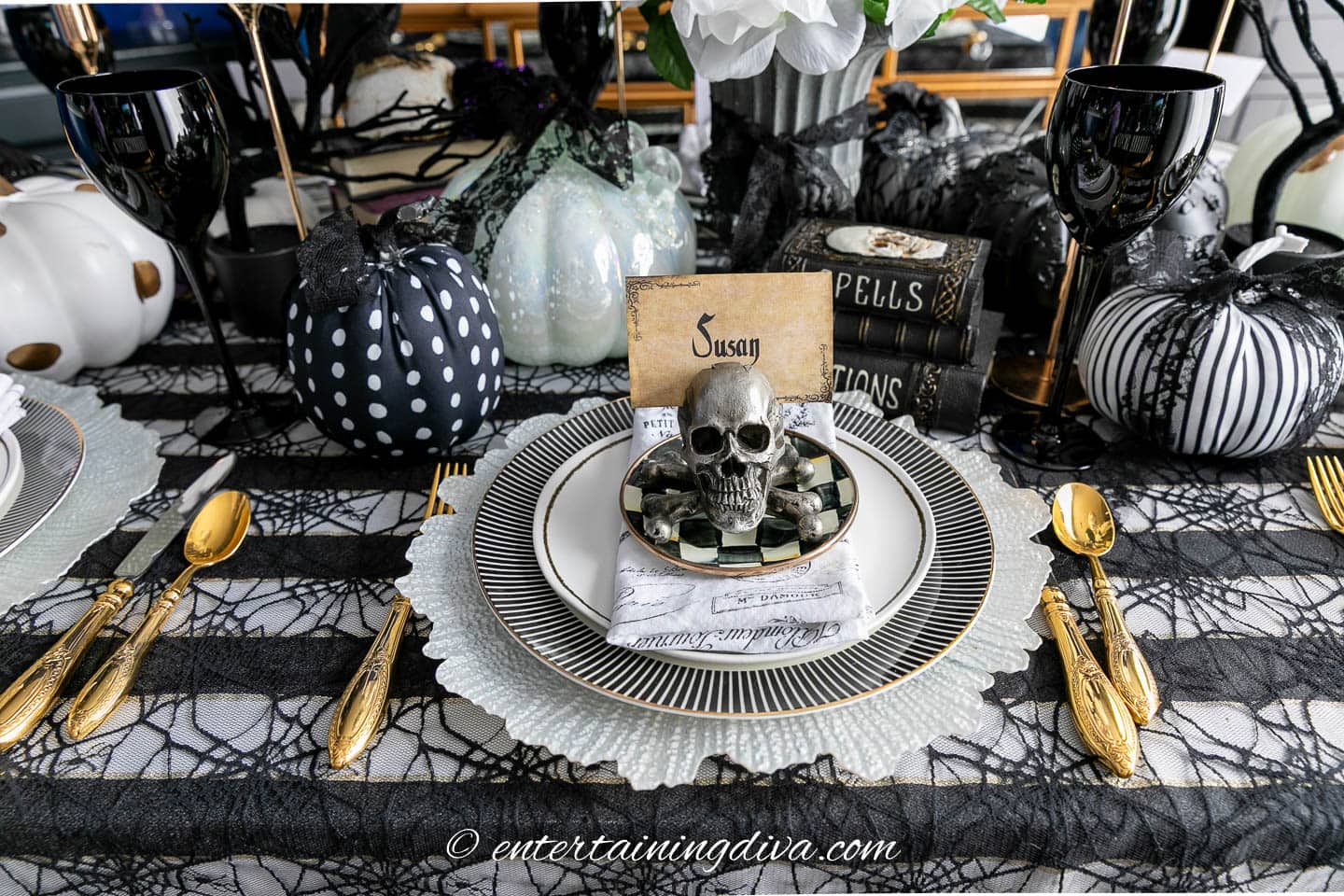 A black and white Halloween tablescape with black lace overlay